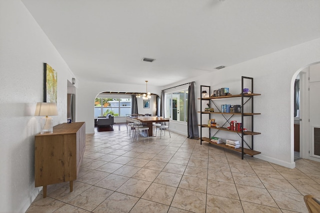 2476 S Florida Mango Rd, West Palm Beach, FL 33406 - dining space featuring arched walkways, light tile patterned flooring, and a chandelier
