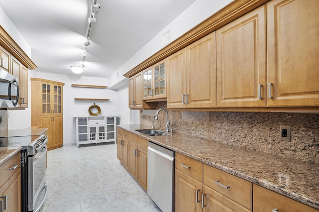 1401 S Ocean Blvd Unit 305, Boca Raton, FL 33432 - kitchen featuring stainless steel appliances, a sink, light stone countertops, decorative backsplash, and glass insert cabinets