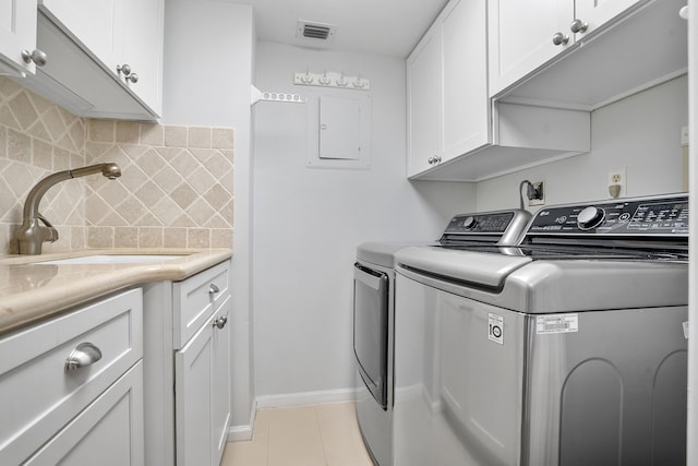 1401 S Ocean Blvd Unit 305, Boca Raton, FL 33432 - laundry room with washer and dryer, cabinet space, light tile patterned flooring, baseboards, and electric panel