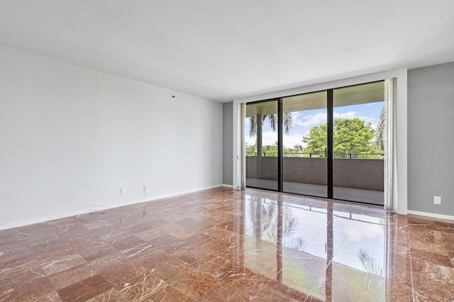 1401 S Ocean Blvd Unit 305, Boca Raton, FL 33432 - unfurnished room featuring marble finish flooring, a wall of windows, and baseboards