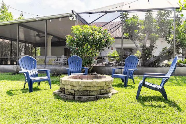 9823 NE Sun Pointe Dr, Boynton Beach, FL 33437 - view of grassy yard with a fire pit and ceiling fan