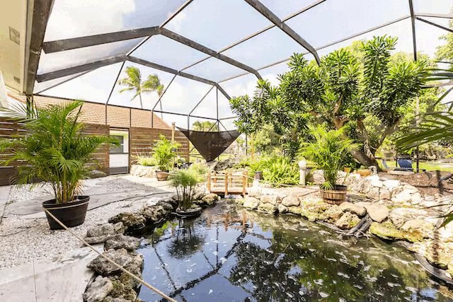 9823 NE Sun Pointe Dr, Boynton Beach, FL 33437 - view of patio featuring a garden pond and a lanai