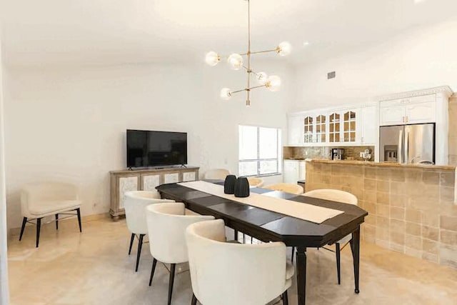 9823 NE Sun Pointe Dr, Boynton Beach, FL 33437 - dining space featuring a chandelier and a high ceiling