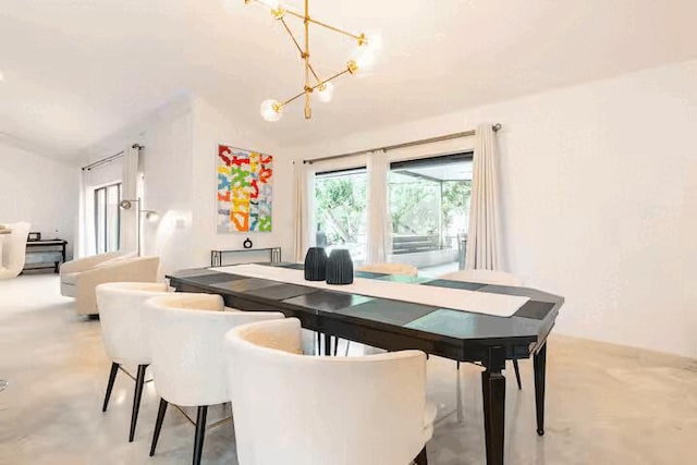 9823 NE Sun Pointe Dr, Boynton Beach, FL 33437 - dining room featuring a chandelier and concrete flooring