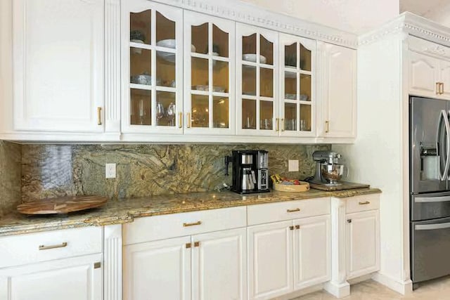 9823 NE Sun Pointe Dr, Boynton Beach, FL 33437 - kitchen featuring stainless steel fridge, glass insert cabinets, tasteful backsplash, and light stone counters