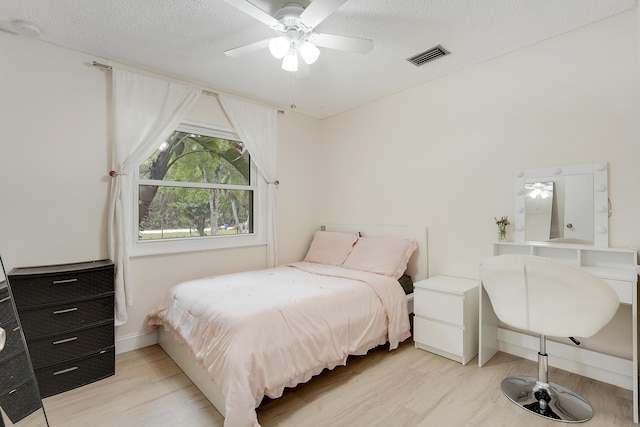 13655 N 68th St N, West Palm Beach, FL 33412 - bedroom with light wood-style flooring, a textured ceiling, and ceiling fan