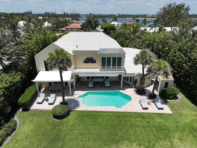 143 E Inlet Dr, Palm Beach, FL 33480 - rear view of house with an outdoor hangout area, a balcony, a yard, a patio area, and an outdoor pool