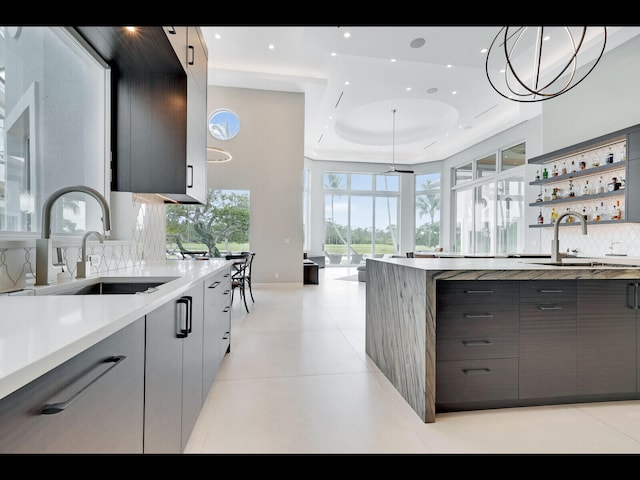 12990 Marsh Lndg, Palm Beach Gardens, FL 33418 - kitchen with gray cabinets, modern cabinets, tasteful backsplash, and recessed lighting