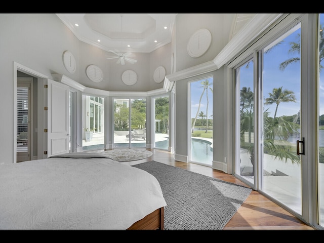 12990 Marsh Lndg, Palm Beach Gardens, FL 33418 - bedroom with a towering ceiling, access to exterior, multiple windows, ornamental molding, and wood finished floors