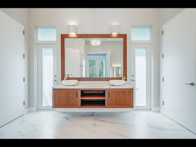 12990 Marsh Lndg, Palm Beach Gardens, FL 33418 - full bath featuring double vanity, marble look tiles, and a chandelier