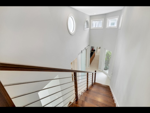 12990 Marsh Lndg, Palm Beach Gardens, FL 33418 - stairway with a high ceiling and wood finished floors