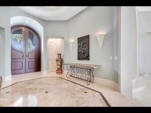 12990 Marsh Lndg, Palm Beach Gardens, FL 33418 - entryway featuring french doors, arched walkways, and marble finish flooring