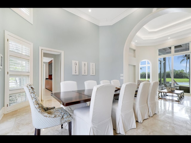 12990 Marsh Lndg, Palm Beach Gardens, FL 33418 - dining room with crown molding, arched walkways, light marble finish floors, and a towering ceiling