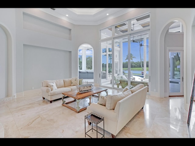 12990 Marsh Lndg, Palm Beach Gardens, FL 33418 - living room featuring arched walkways, a towering ceiling, marble tiled flooring, ornamental molding, and recessed lighting