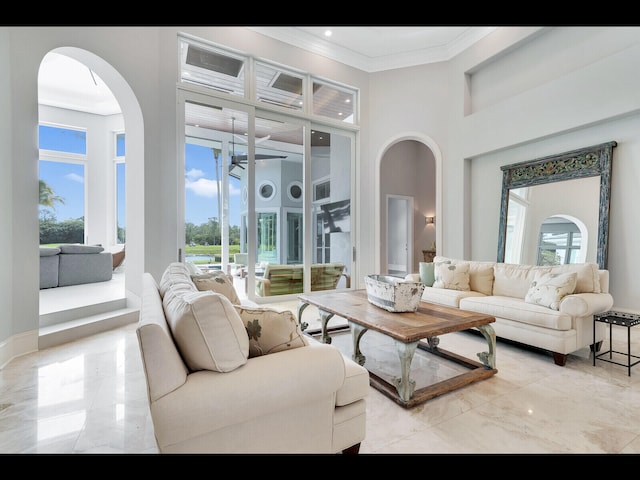12990 Marsh Lndg, Palm Beach Gardens, FL 33418 - living area featuring marble tiled floors, arched walkways, a towering ceiling, crown molding, and ceiling fan