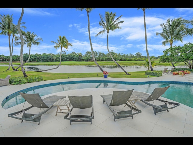 12990 Marsh Lndg, Palm Beach Gardens, FL 33418 - swimming pool with a water view, a lawn, a patio, and view of wooded area