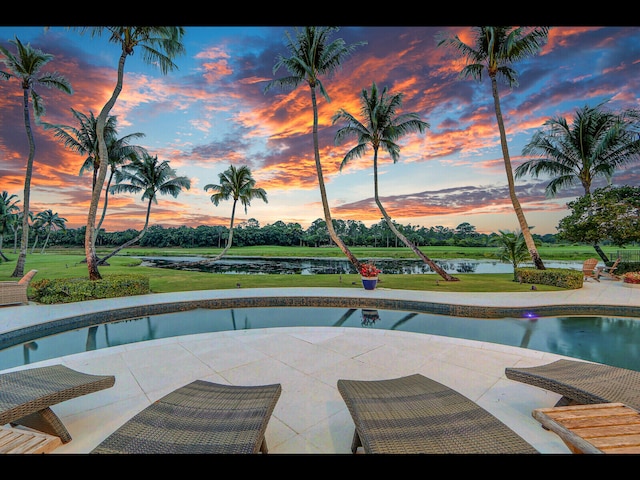 12990 Marsh Lndg, Palm Beach Gardens, FL 33418 - pool at dusk featuring an outdoor pool, a patio area, and a water view