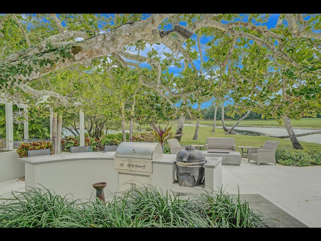 12990 Marsh Lndg, Palm Beach Gardens, FL 33418 - view of patio / terrace featuring area for grilling and a water view
