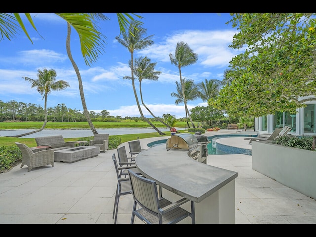 12990 Marsh Lndg, Palm Beach Gardens, FL 33418 - view of patio featuring a grill, a water view, an outdoor pool, and an outdoor fire pit