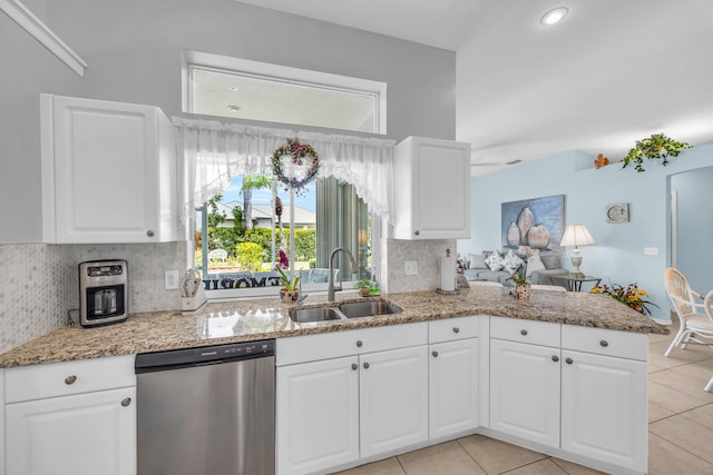 3592 SW Rosser Blvd, Port Saint Lucie, FL 34953 - kitchen featuring stainless steel dishwasher, a sink, light stone counters, decorative backsplash, and light tile patterned floors