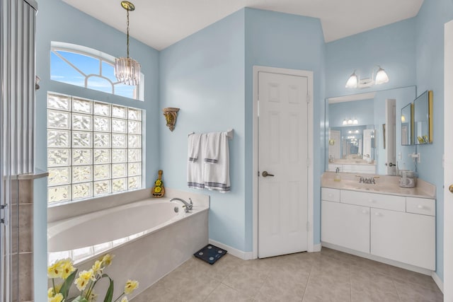 3592 SW Rosser Blvd, Port Saint Lucie, FL 34953 - bathroom featuring vanity, a bath, tile patterned flooring, a chandelier, and baseboards