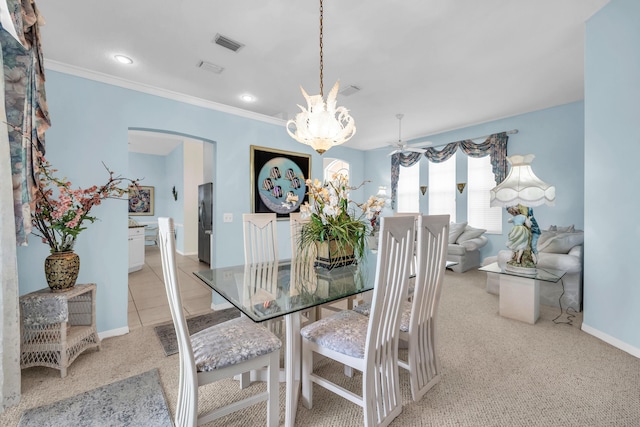 3592 SW Rosser Blvd, Port Saint Lucie, FL 34953 - dining room featuring a chandelier, arched walkways, light colored carpet, baseboards, and ornamental molding