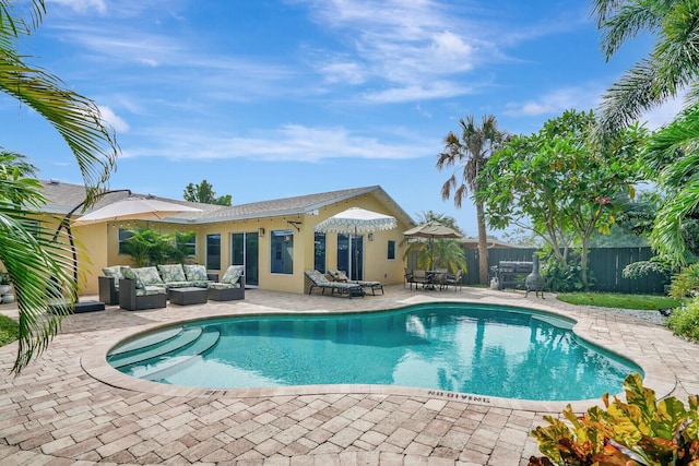 943 Macy St, West Palm Beach, FL 33405 - view of swimming pool with outdoor lounge area, a patio, and a fenced backyard
