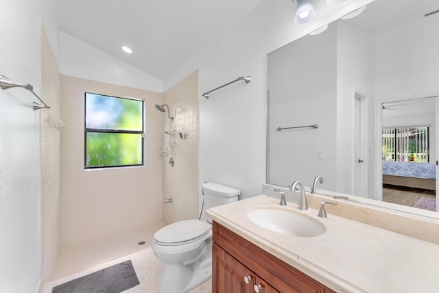 3099 NW 28th Ter, Boca Raton, FL 33434 - bathroom featuring a tile shower, toilet, vanity, lofted ceiling, and connected bathroom