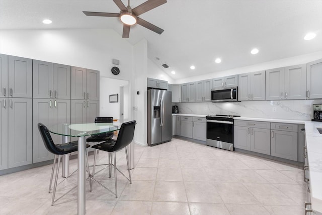 3099 NW 28th Ter, Boca Raton, FL 33434 - kitchen with stainless steel appliances, gray cabinets, a ceiling fan, light countertops, and decorative backsplash