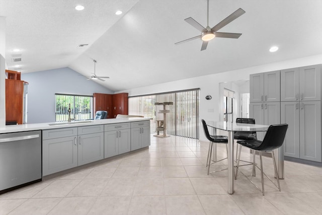 3099 NW 28th Ter, Boca Raton, FL 33434 - kitchen with stainless steel dishwasher, a ceiling fan, gray cabinets, lofted ceiling, and a sink