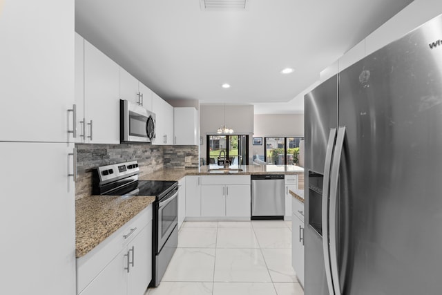 5255 Monterey Cir Unit G, Delray Beach, FL 33484 - kitchen with stainless steel appliances, a sink, light marble finish flooring, backsplash, and white cabinets
