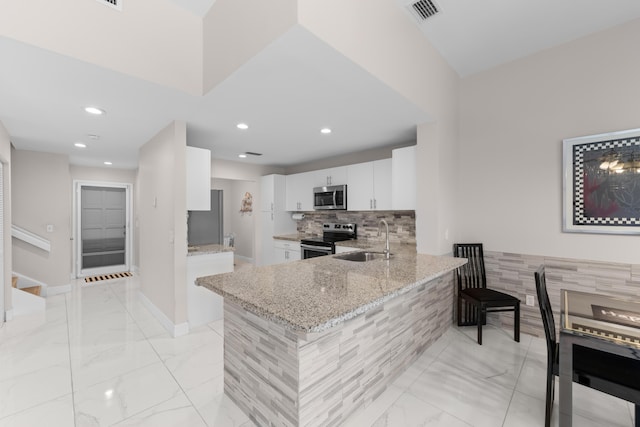 5255 Monterey Cir Unit G, Delray Beach, FL 33484 - kitchen featuring stainless steel appliances, a sink, light stone counters, white cabinets, and light marble finish flooring