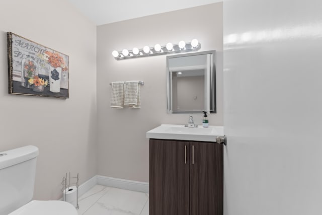 5255 Monterey Cir Unit G, Delray Beach, FL 33484 - bathroom featuring marble finish floors, toilet, vanity, and baseboards