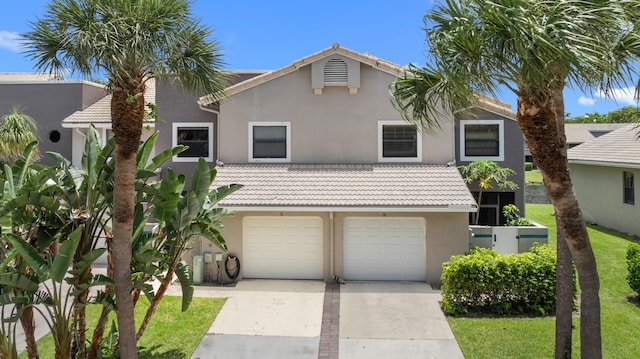 5255 Monterey Cir Unit G, Delray Beach, FL 33484 - multi unit property featuring concrete driveway, stucco siding, a tile roof, and a garage