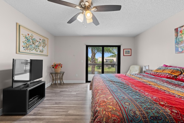 5255 Monterey Cir Unit G, Delray Beach, FL 33484 - bedroom featuring access to exterior, wood finished floors, a textured ceiling, ceiling fan, and baseboards