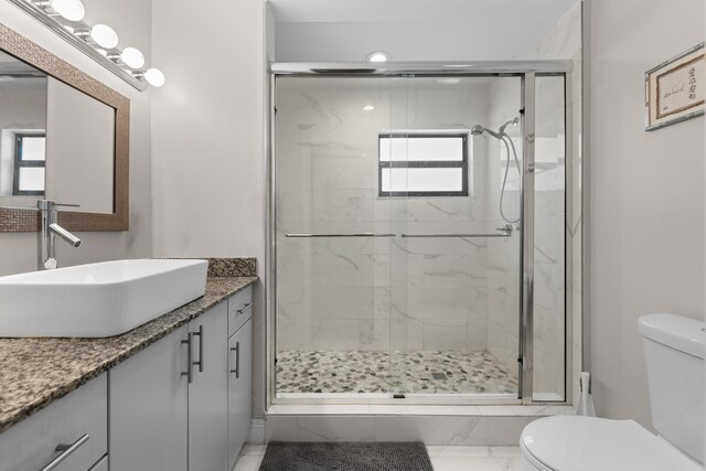 5255 Monterey Cir Unit G, Delray Beach, FL 33484 - bathroom with toilet, vanity, a stall shower, and marble finish floors