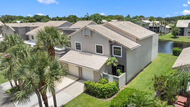 5255 Monterey Cir Unit G, Delray Beach, FL 33484 - view of front facade with stucco siding, a tiled roof, concrete driveway, and a water view