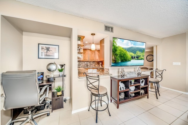 6372 La Costa Dr Unit 306, Boca Raton, FL 33433 - bar featuring a textured ceiling, backsplash, light tile patterned flooring, and baseboards