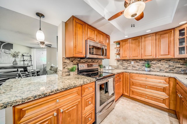 6372 La Costa Dr Unit 306, Boca Raton, FL 33433 - kitchen with appliances with stainless steel finishes, ceiling fan, light stone countertops, and decorative backsplash