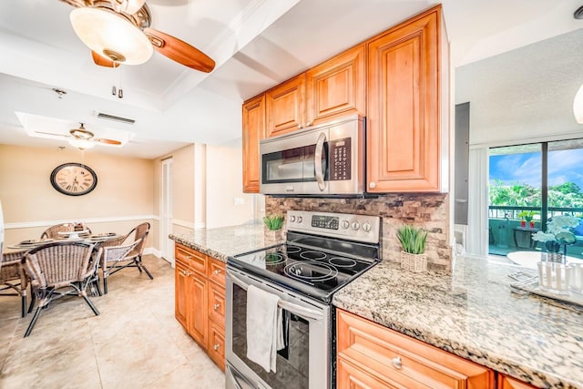 6372 La Costa Dr Unit 306, Boca Raton, FL 33433 - kitchen with appliances with stainless steel finishes, ceiling fan, light stone counters, tasteful backsplash, and a raised ceiling