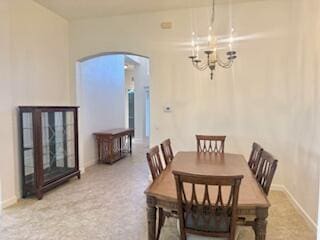 344 NW Stratford Ln, Port Saint Lucie, FL 34983 - dining area with arched walkways, a chandelier, and baseboards