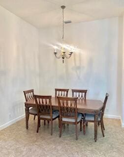 344 NW Stratford Ln, Port Saint Lucie, FL 34983 - dining area with a chandelier and baseboards