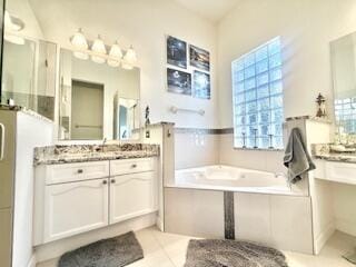 344 NW Stratford Ln, Port Saint Lucie, FL 34983 - bathroom with vanity, a bath, and tile patterned floors