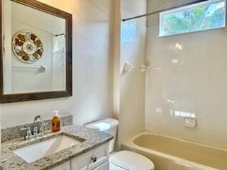344 NW Stratford Ln, Port Saint Lucie, FL 34983 - full bathroom featuring toilet, vanity, and washtub / shower combination