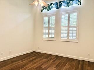 344 NW Stratford Ln, Port Saint Lucie, FL 34983 - empty room with baseboards, a ceiling fan, and dark wood-type flooring