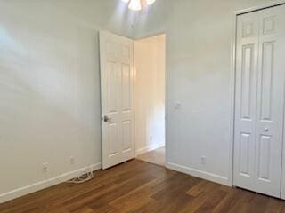 344 NW Stratford Ln, Port Saint Lucie, FL 34983 - unfurnished bedroom featuring baseboards, wood finished floors, and a closet