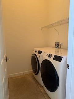 344 NW Stratford Ln, Port Saint Lucie, FL 34983 - washroom featuring washing machine and dryer and baseboards
