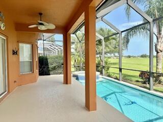 344 NW Stratford Ln, Port Saint Lucie, FL 34983 - swimming pool with glass enclosure, a patio area, and ceiling fan