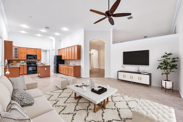 1415 SE Legacy Cove Cir, Stuart, FL 34997 - living area featuring light tile patterned floors, crown molding, a ceiling fan, arched walkways, and recessed lighting