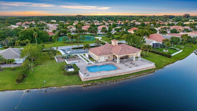 1415 SE Legacy Cove Cir, Stuart, FL 34997 - aerial view at dusk of a water view, view of pool, and a residential view